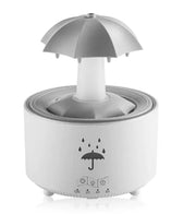 Humidificateur rotatif blanc en forme de goutte, idéal pour l'aromathérapie et la relaxation à domicile.