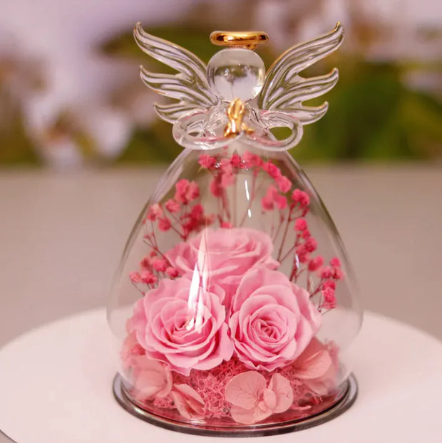Décoration bouteille en verre fleur séchée avec des roses roses et un ange en verre