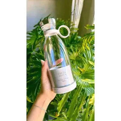 Beautysky portable blender for smoothies in a sleek design held against a backdrop of lush greenery