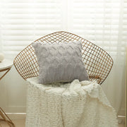Housse coussin fourrure grise sur un fauteuil, ajoutant une touche cosy à la décoration intérieure