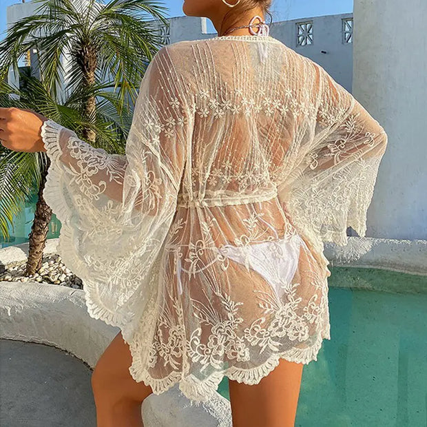 Elegant lace beach cover-up robe with delicate crochet patterns, ideal for summer vacations.