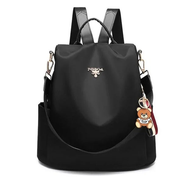 Sac à dos Oxford imperméable noir pour femmes avec breloque ours, design moderne.