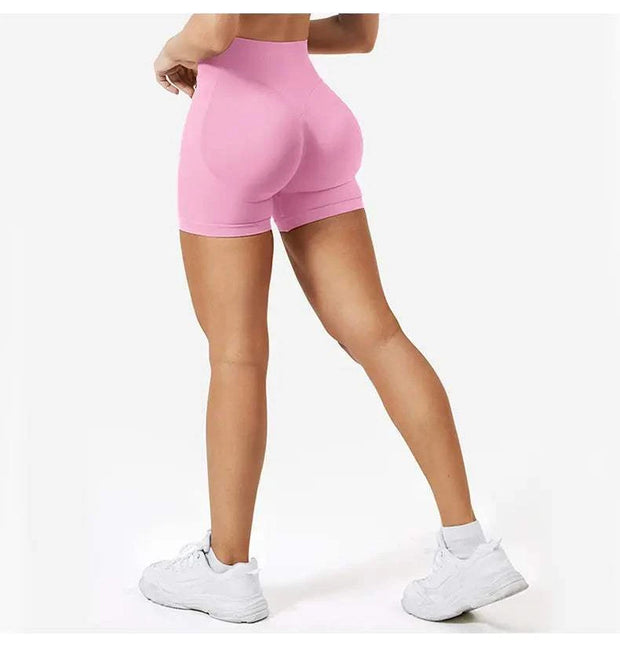 Short de yoga taille haute en rose, offrant confort et style pour vos séances de sport.