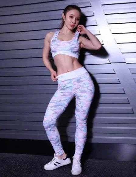 Woman wearing a camouflage yoga jumpsuit showcasing flexibility and style.